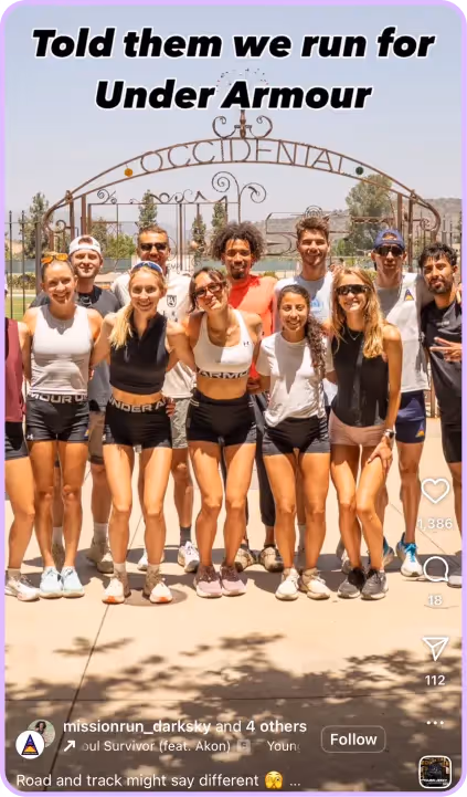 Running group posing under Occidental arch wearing Under Armour apparel