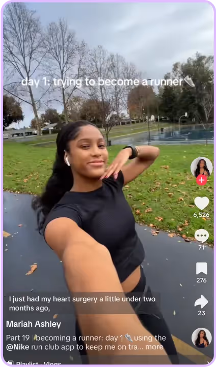 Young woman filming day one of her running journey on a tree-lined path