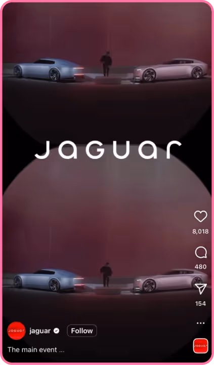 Jaguar showcases two sleek concept cars on a dark stage with ambient lighting and a person between them.