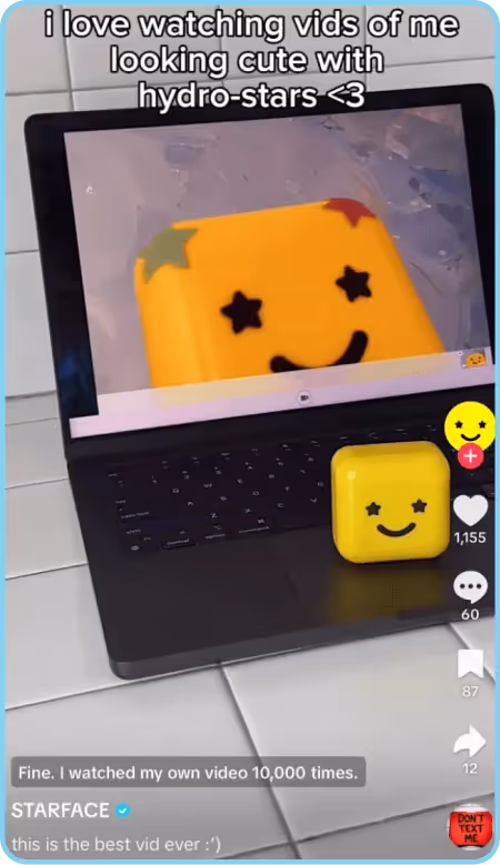 Starface TikTok showing yellow smiley container watching itself on a laptop screen.