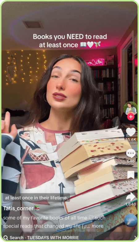 TikTok creator recommending books to read at least once while holding a stack.
