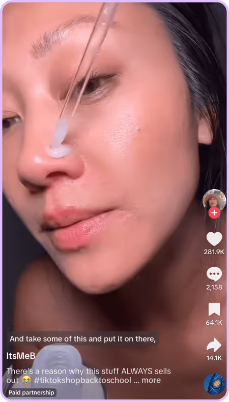 Close-up of woman applying skincare serum with dropper in TikTok video tutorial