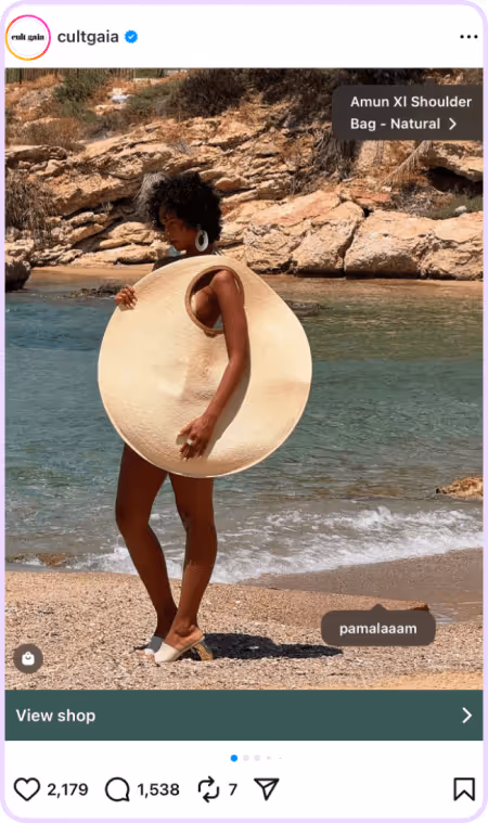 Woman on beach wearing oversized circular sunhat styled as a dress