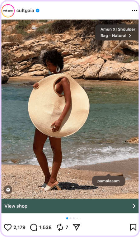 Woman on beach wearing oversized circular sunhat styled as a dress