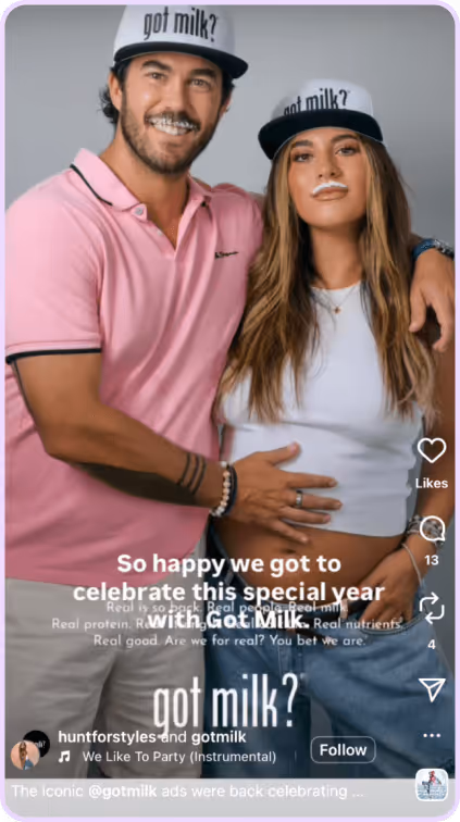 Couple in Got Milk? ad posing together, both wearing branded hats and smiling