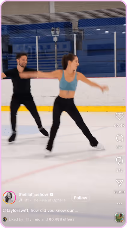 Figure skating duo performing a routine on an indoor ice rink with arms extended.