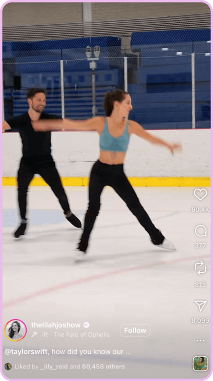 Figure skating duo performing a routine on an indoor ice rink with arms extended.