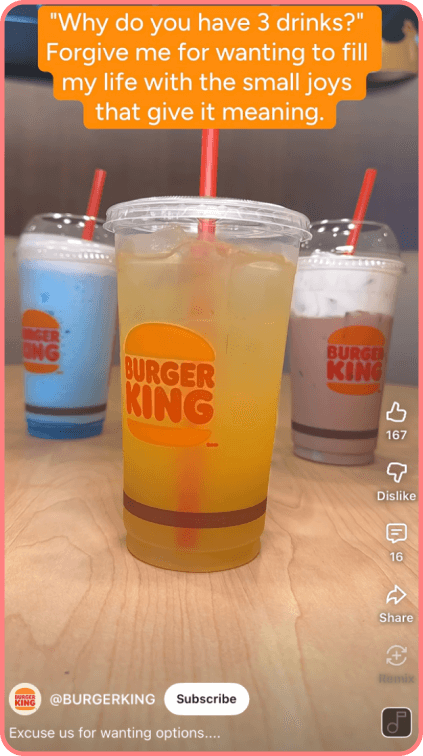 Three Burger King drinks on a wooden table with colorful straws and branded cups.