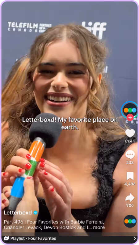 Woman smiling in black dress during Letterboxd interview at TIFF.