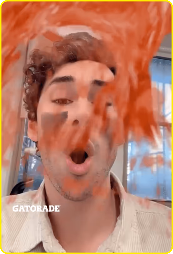 Man with face paint reacts as red Gatorade snapchat splash effect covers the screen