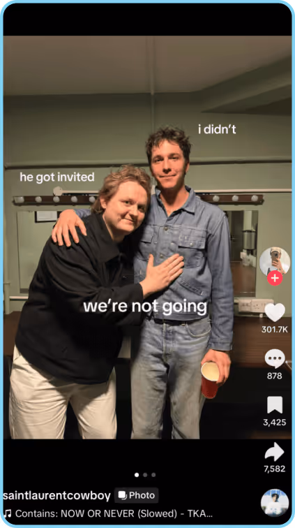 Two men pose backstage, one with arm around the other and humorous text above.