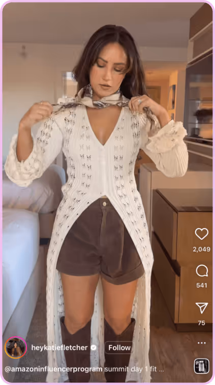 Woman adjusting scarf while wearing a white crochet top, brown shorts, and knee-high boots.