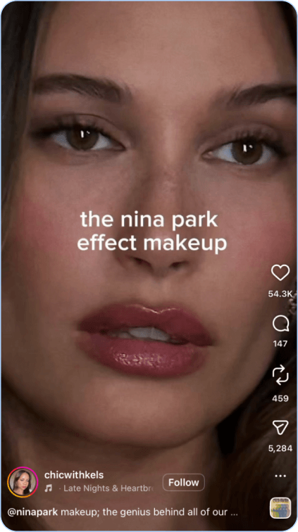 Close-up of woman's face showcasing soft glam makeup with glossy lips.