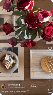 Red roses on wooden table with books and cozy decor
