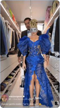 Woman in dramatic blue gown and mask in walk-in closet