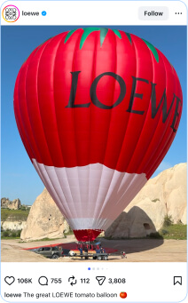 hot air balloon colored like a tomato ready to take off the ground