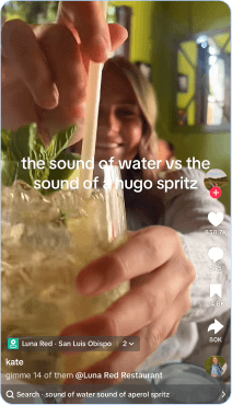 Friends comparing water and Hugo spritz drinks at Luna Red restaurant bar