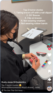 orthodontist demonstrating clear aligner care and braces tools at dental office