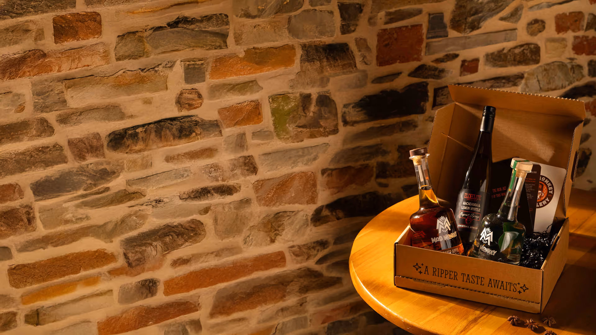A bottle of liquor is sitting on a wooden table.