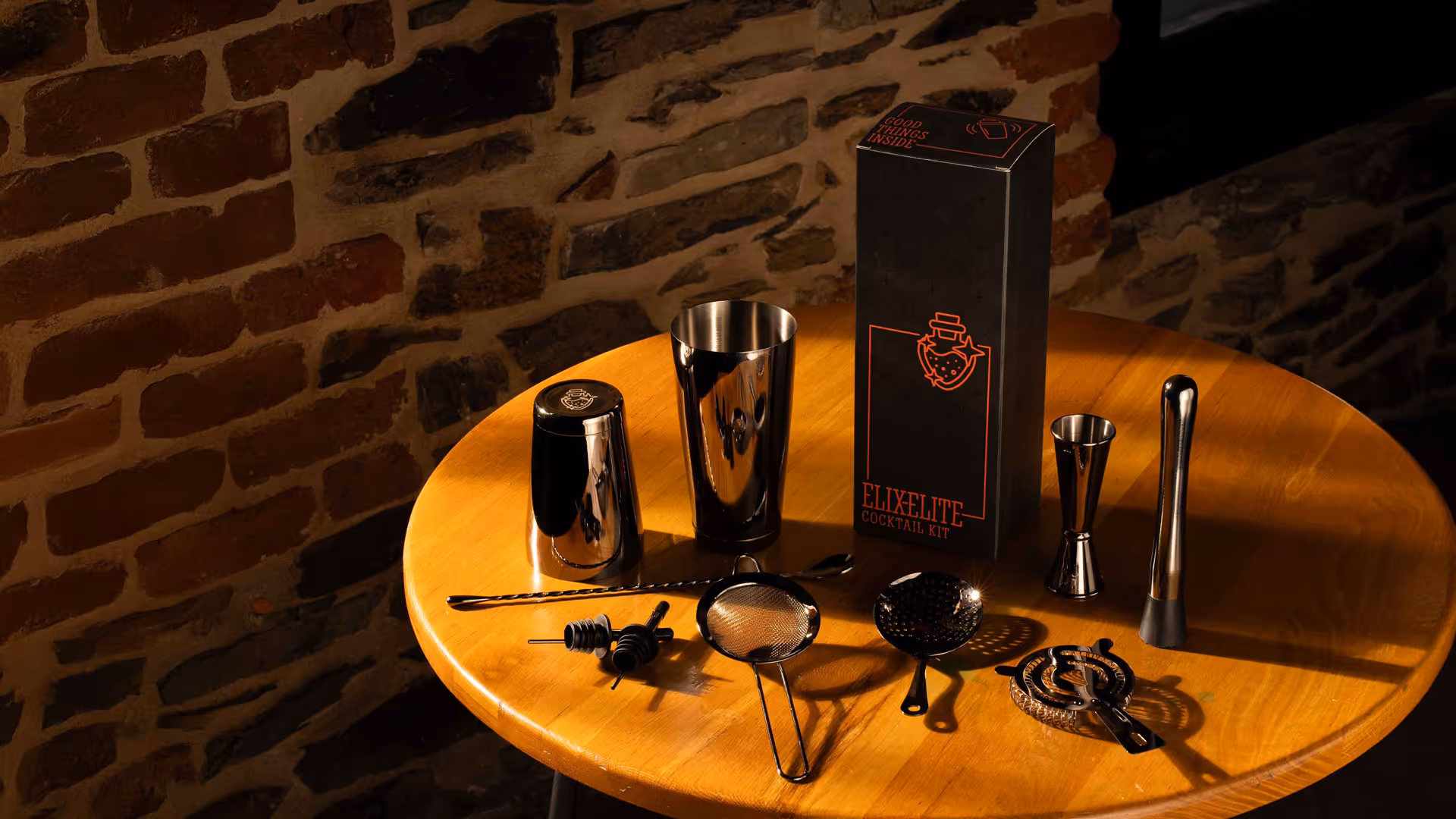 A box of Elite branded drinking glasses and utensils.