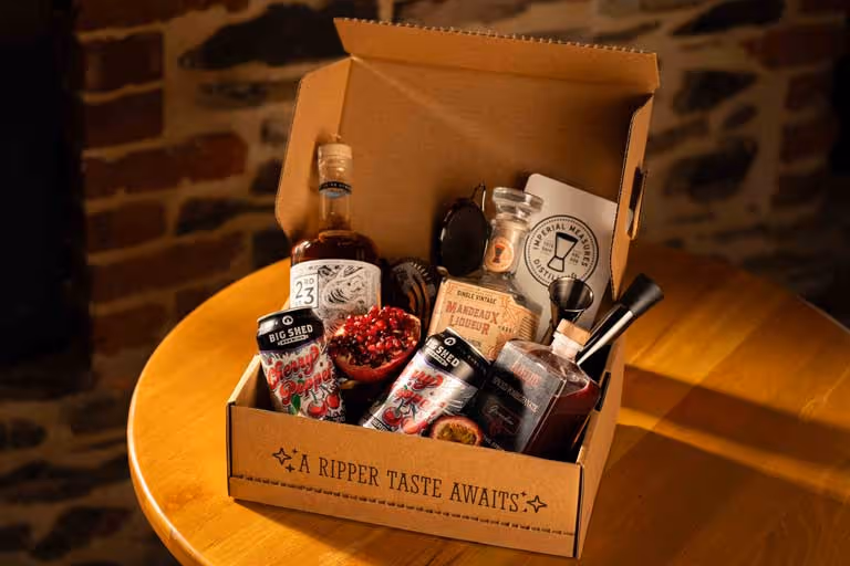 A box of various items including a bottle of alcohol.