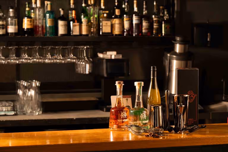 A bottle of tequila sits on a bar counter.