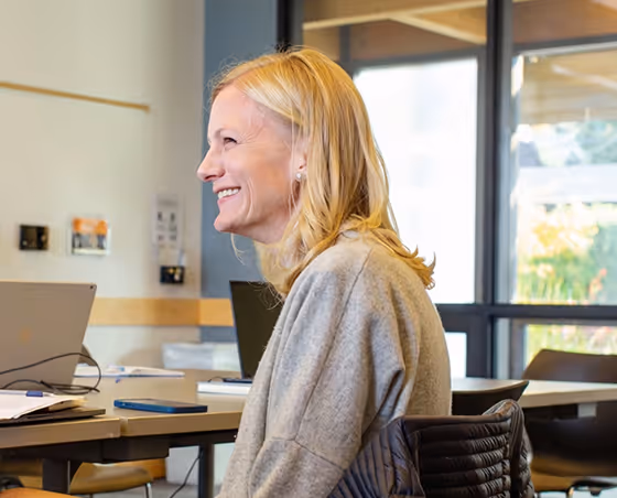 Team meeting at Artemis Connection with members enjoying a moment of laughter and collaboration