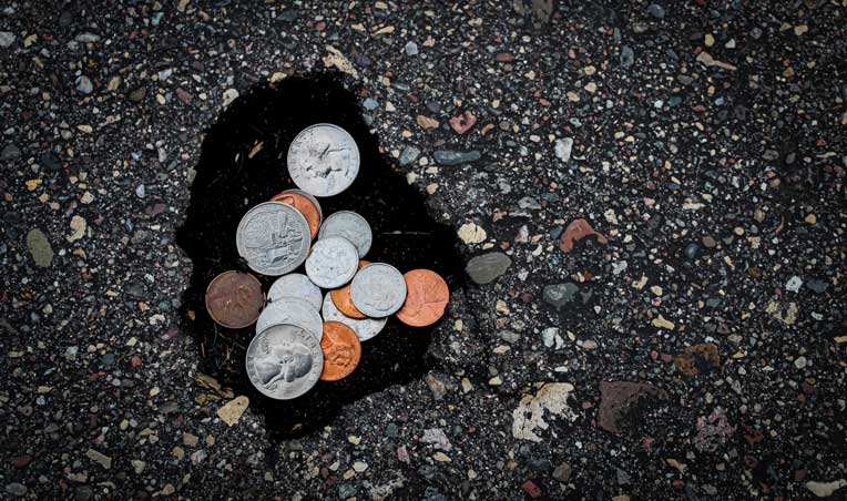 Image of coins on a road