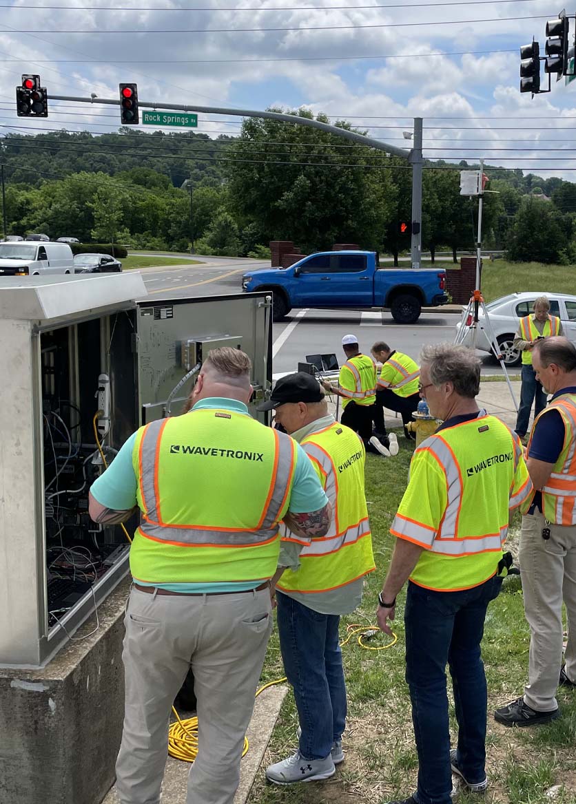 Image of Roadside demo with technicians configuring an intersection at a traffic cabinet