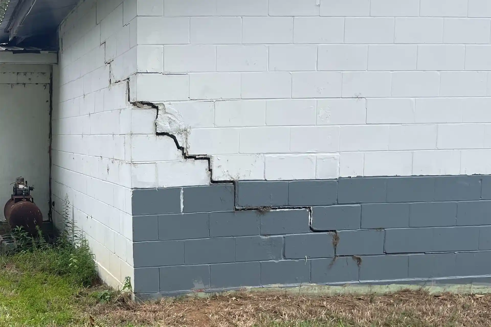 Foundation settlement service page showing sunken and tilted foundation requiring pier stabilization in Alabama