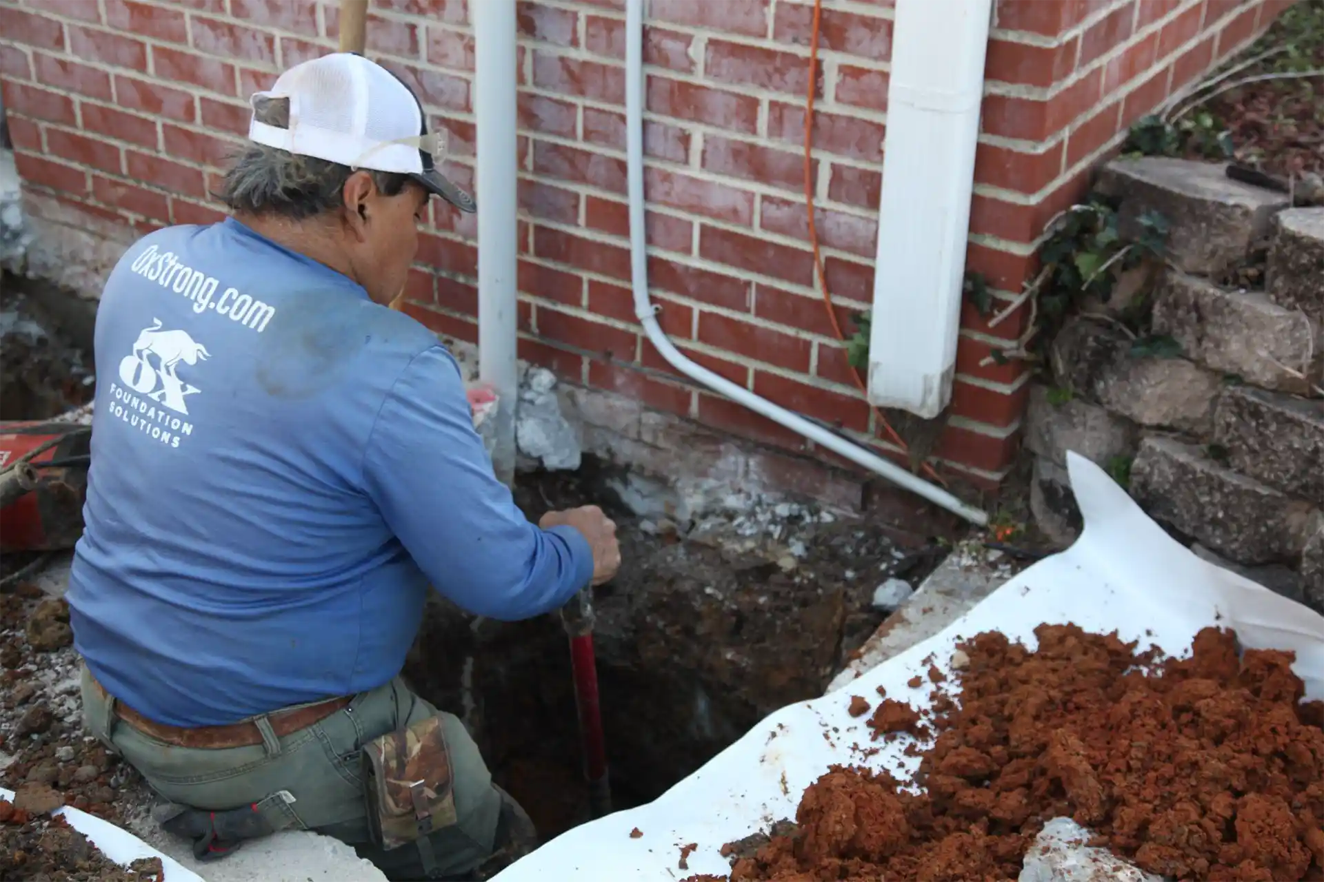Foundation stabilization service using steel piers and anchors to halt settlement in Alabama home