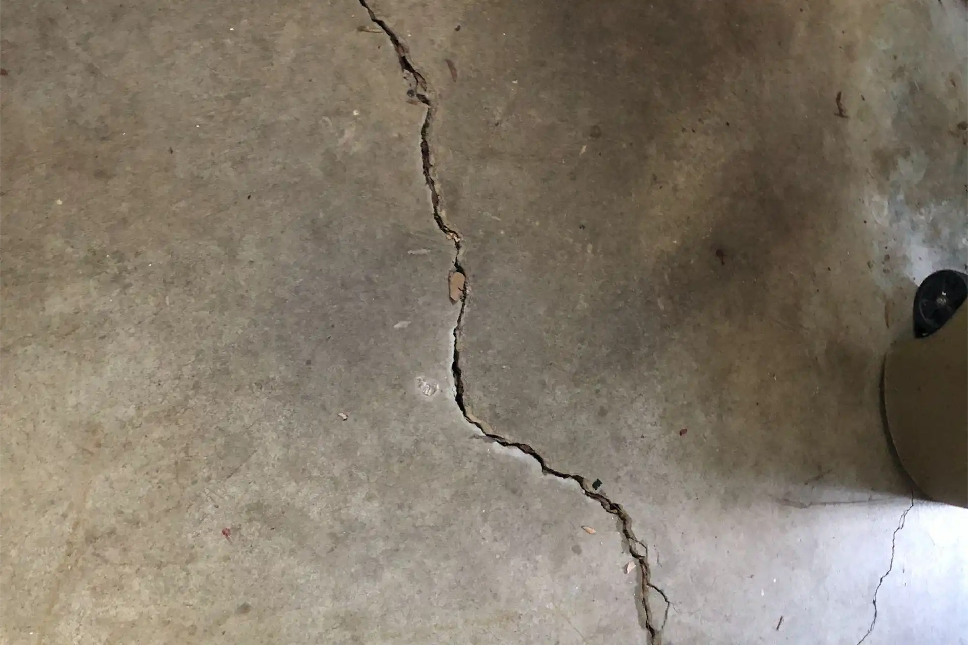Sunken and cracked garage floor concrete leveling and repair service by Ox Foundation Solutions in Alabama
