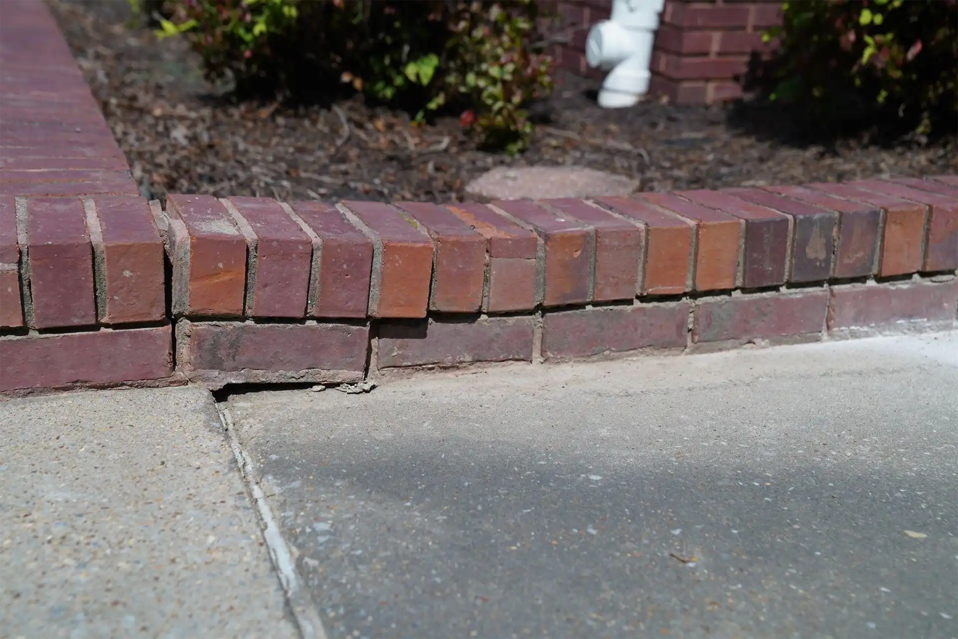 Cracked and settled sidewalk concrete leveling repair using polyurethane foam injection in Alabama