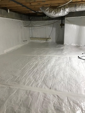 Encapsulated crawl space with white vapor barrier lining floor and walls, exposed joists and insulated HVAC duct overhead