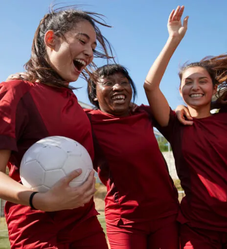 A group of girls playing soccer