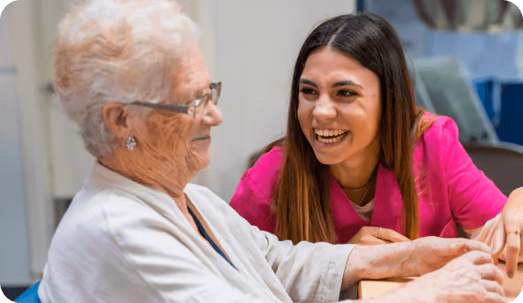 A woman talking to an older woman