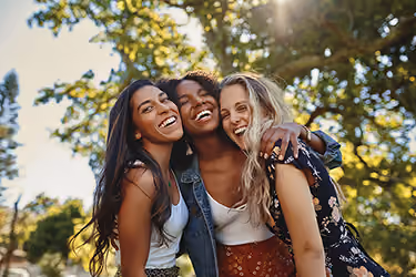 3 girls hugging and smiling 