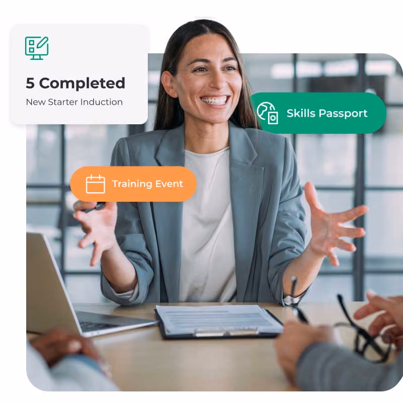 Person gesturing during a meeting with digital badges for completed training and skills.