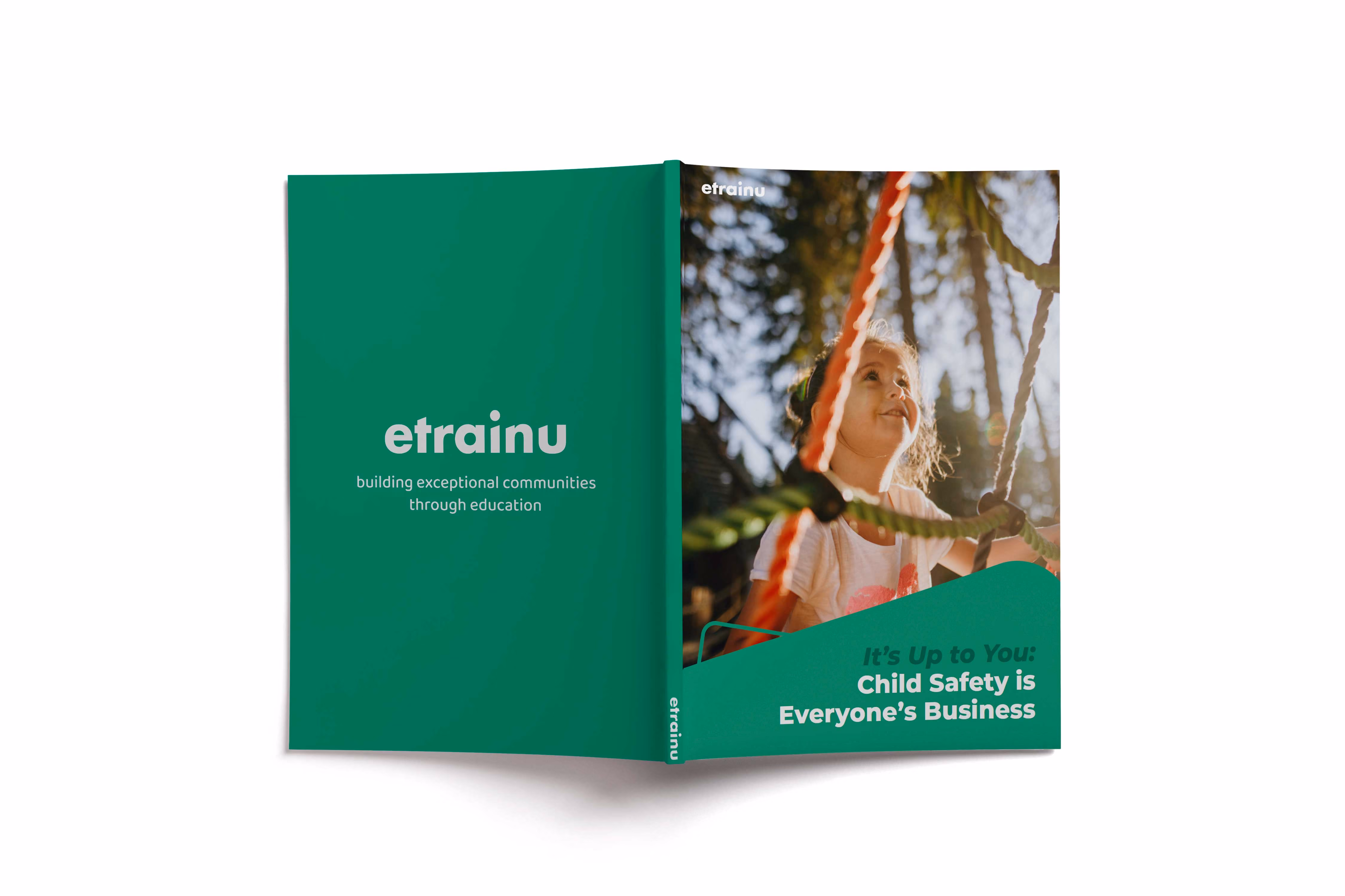 Opened booklet titled 'It’s Up to You: Child Safety is Everyone’s Business' with photo of a smiling child climbing playground ropes.