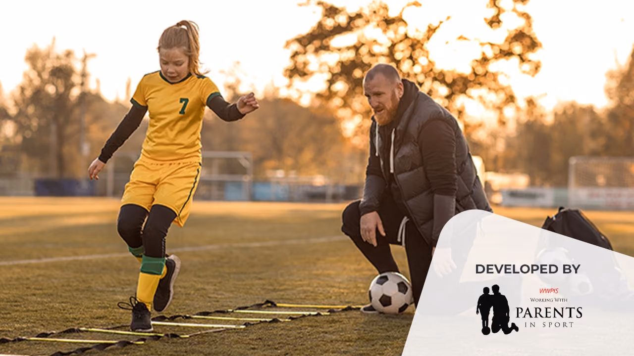 A teenage girl with her male soccer coach doing drills
