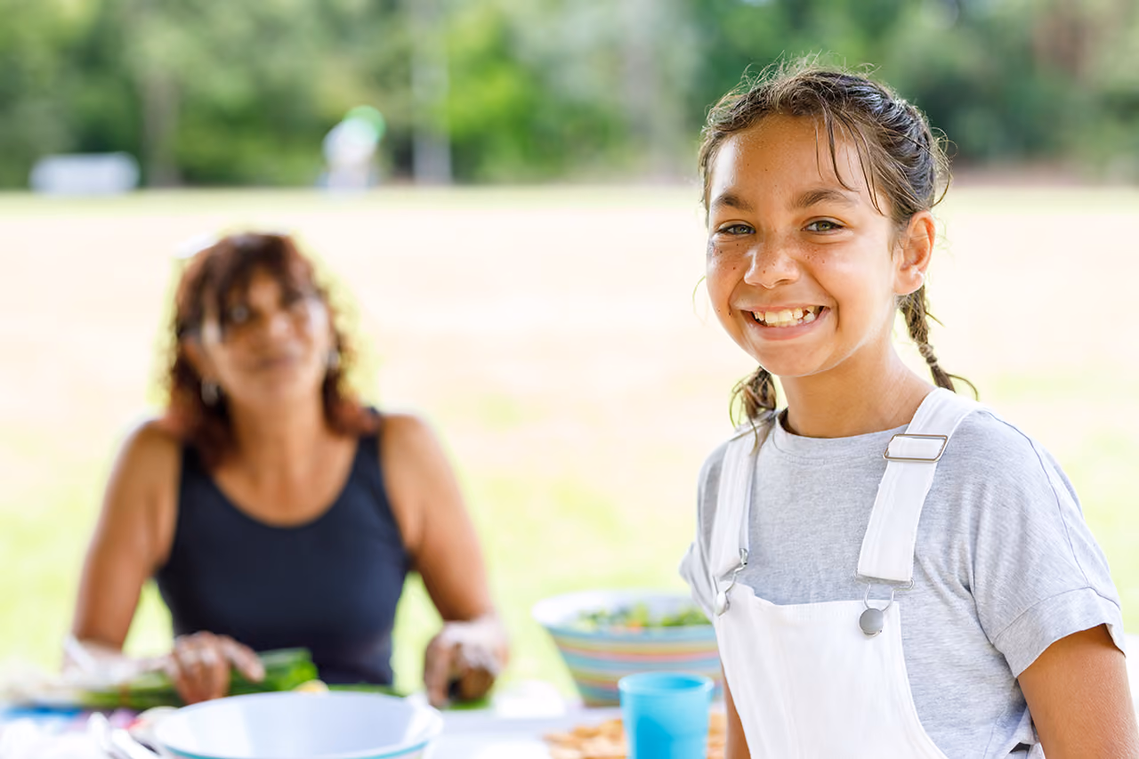 A young teenage girl smiling at the camera