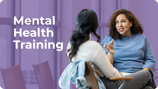 Two women engaged in conversation during a mental health training session.
