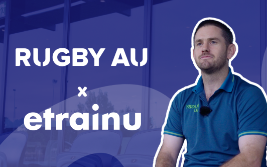 Man in a blue Rugby AU polo shirt sitting with a background showing Rugby AU and etrainu logos.