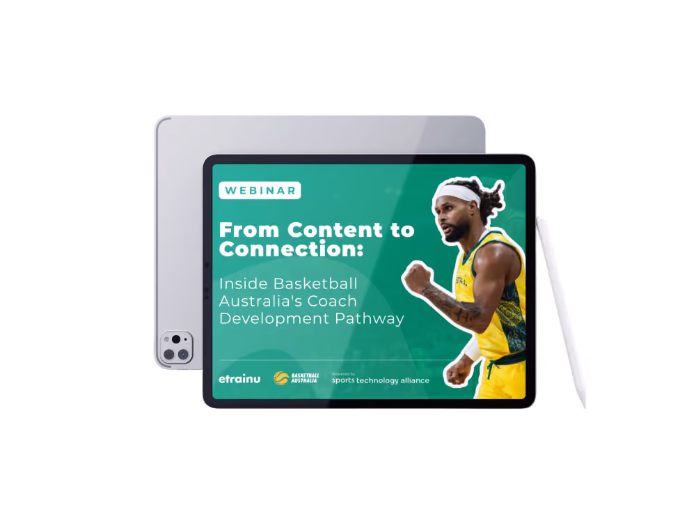 Tablet displaying a webinar titled 'From Content to Connection: Inside Basketball Australia's Coach Development Pathway' with a basketball player in yellow and green uniform and headband on the right side. Logos for etrainu, Basketball Australia, and Sports Technology Alliance appear at the bottom.