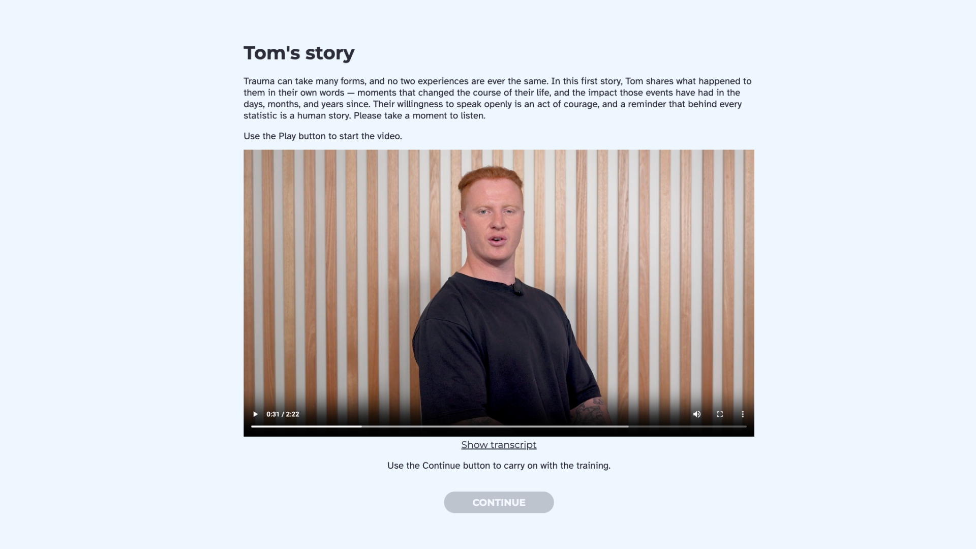 A man speaks to camera against a timber slat wall, in the "Tom's story" video.
