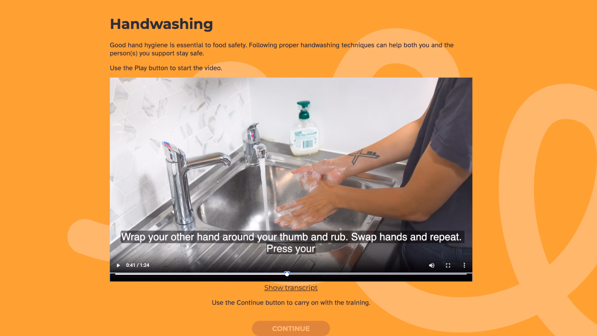 Handwashing' lesson screen explaining that good hand hygiene is essential to food safety, with an embedded video showing a person lathering and washing their hands under running water at a kitchen sink.