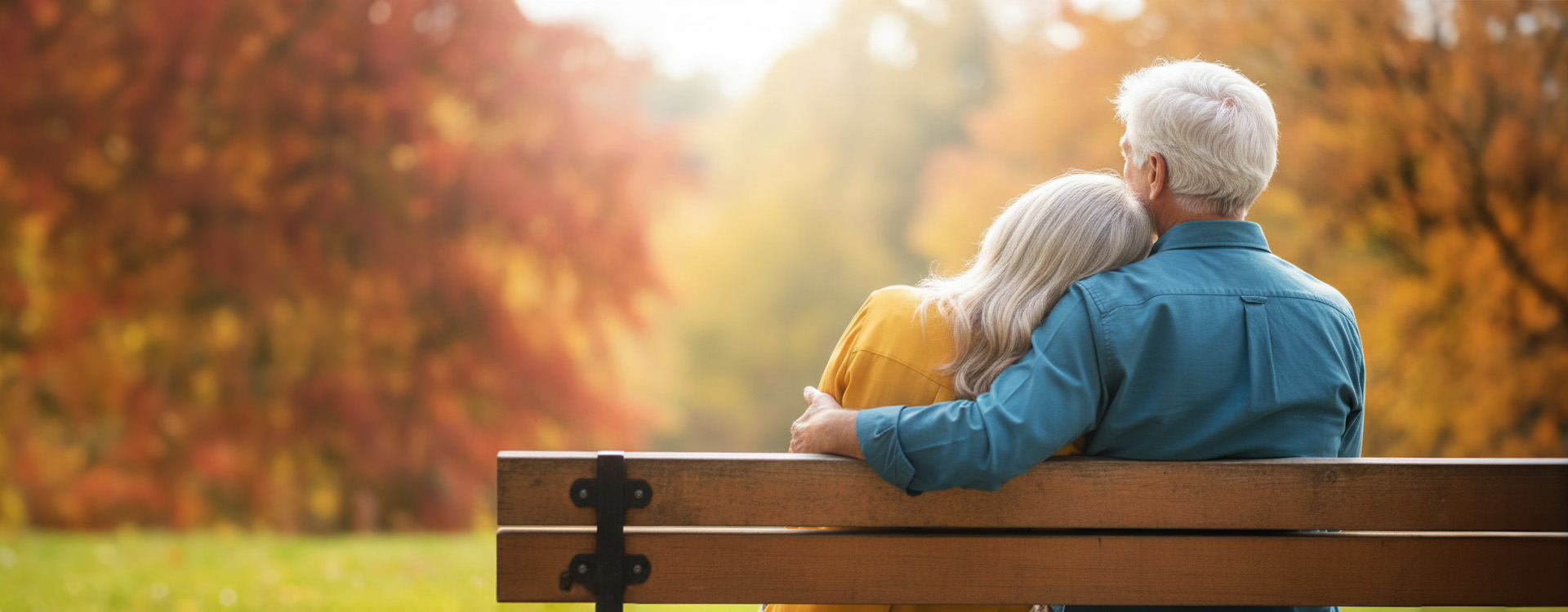 Older couple sitting together on a park bench