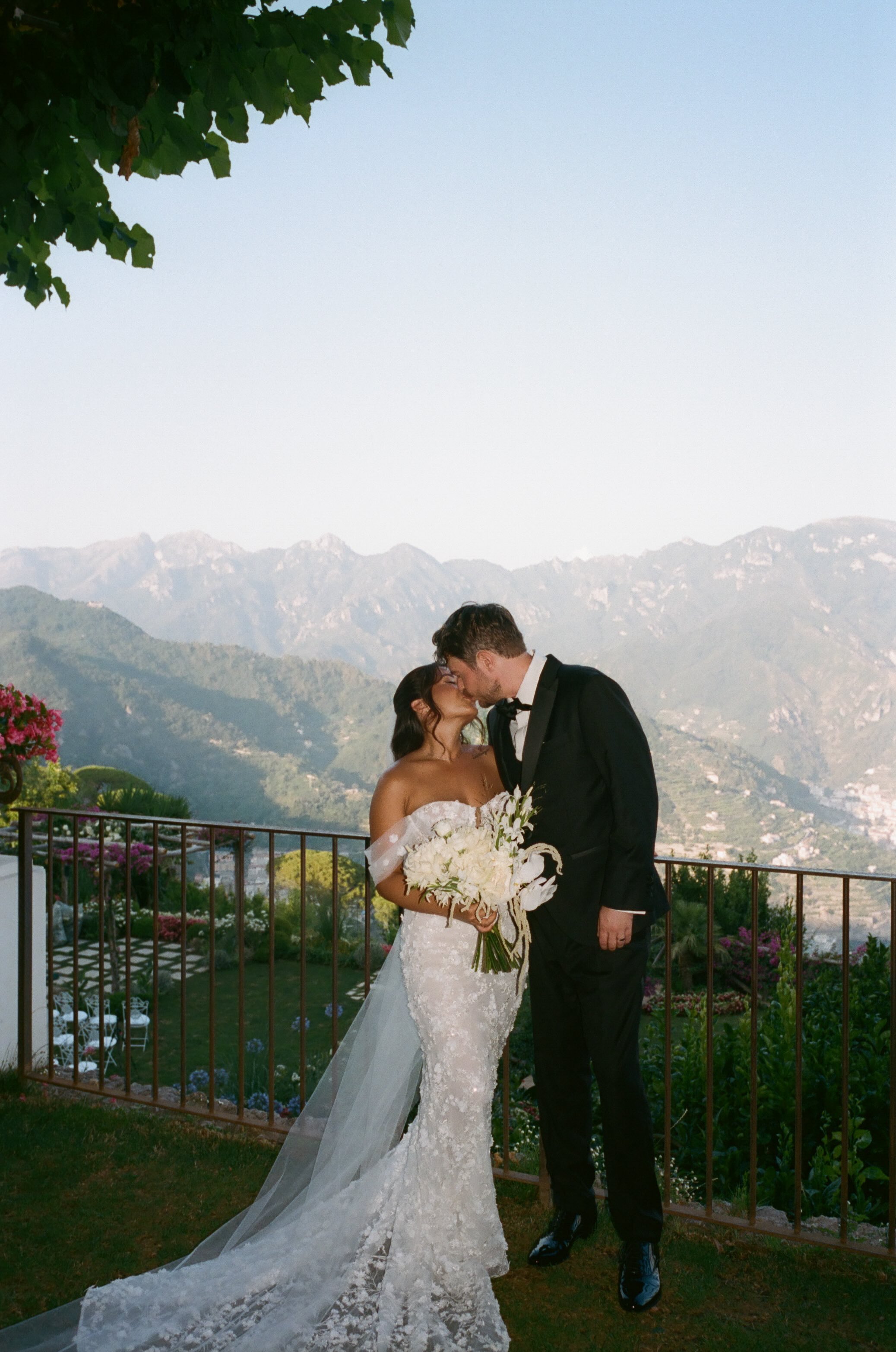 Bride in lace gown on terrace overlooking Amalfi Coast — destination wedding by Wedding Mark
