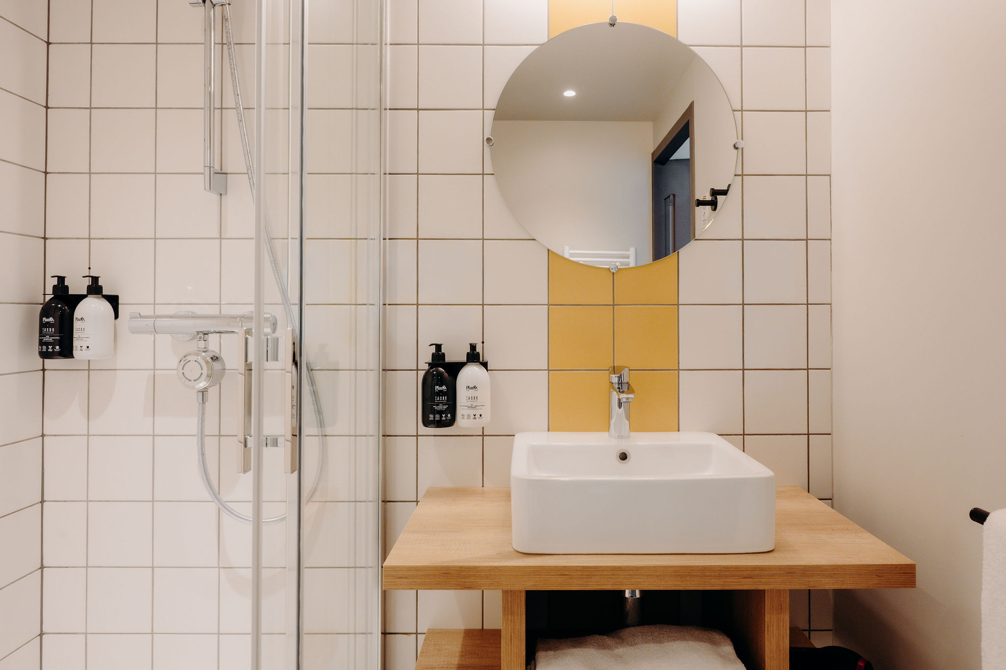 A modern, functional bathroom with shower, toilet and toiletries, for a comfortable stay.
