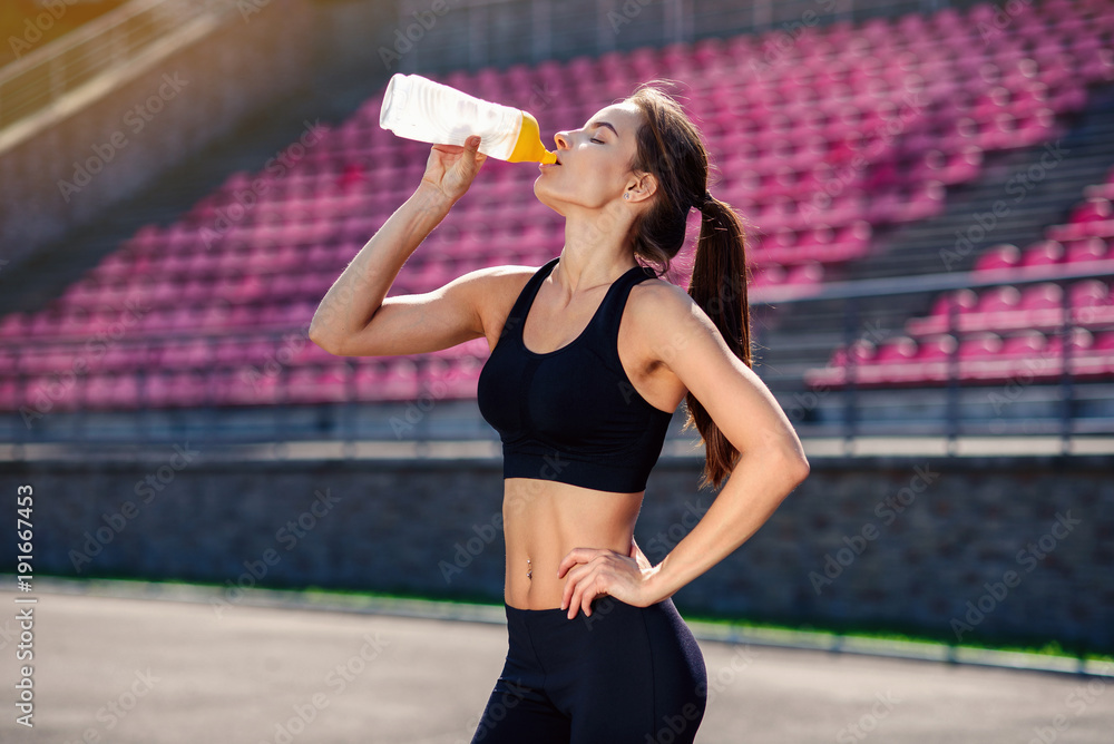 Woman Drinking Water During Exercise